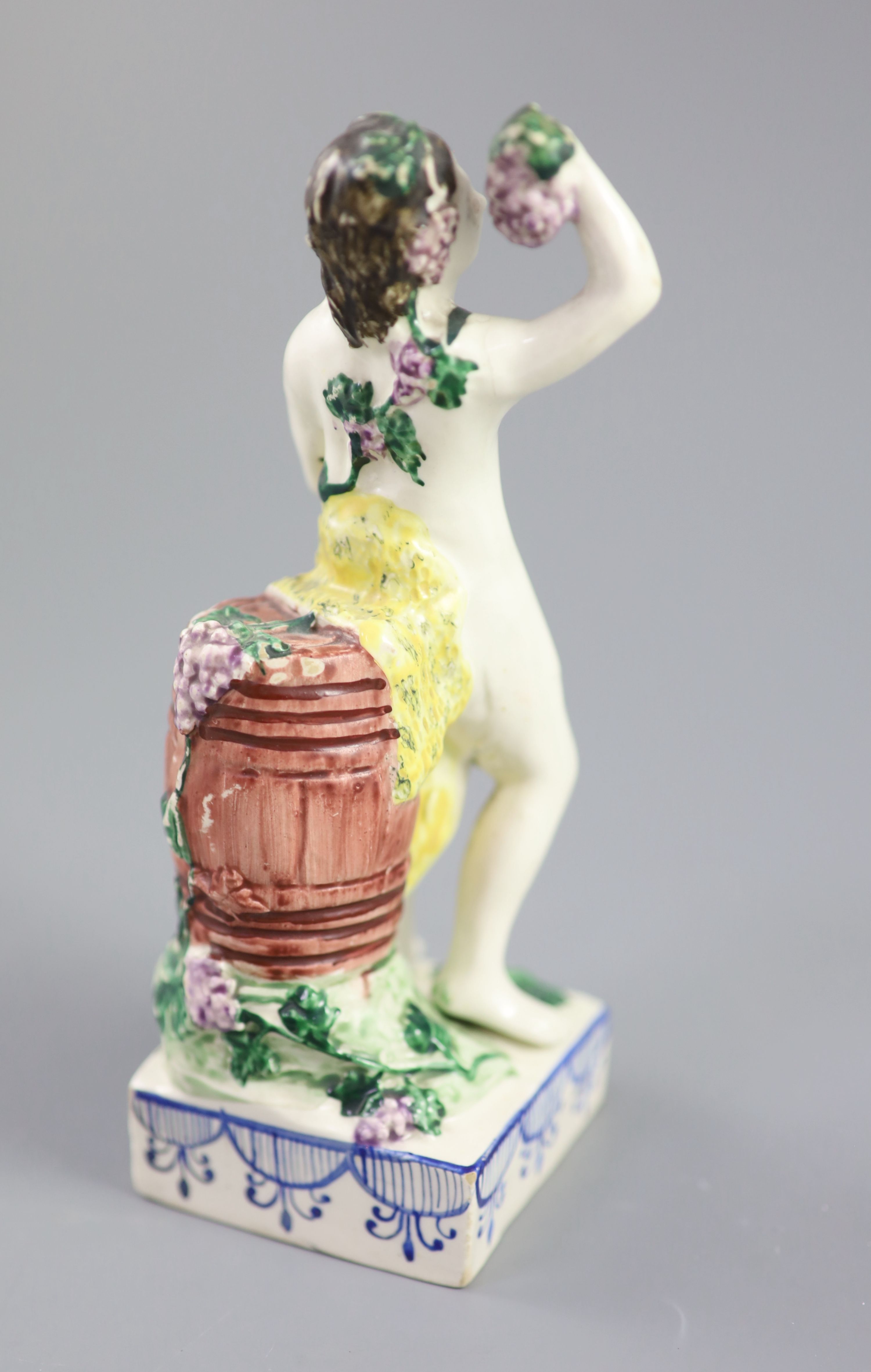 An enamelled creamware figure of Bacchus, attributed Leeds Pottery, c.1790-1800, 17.5cm high